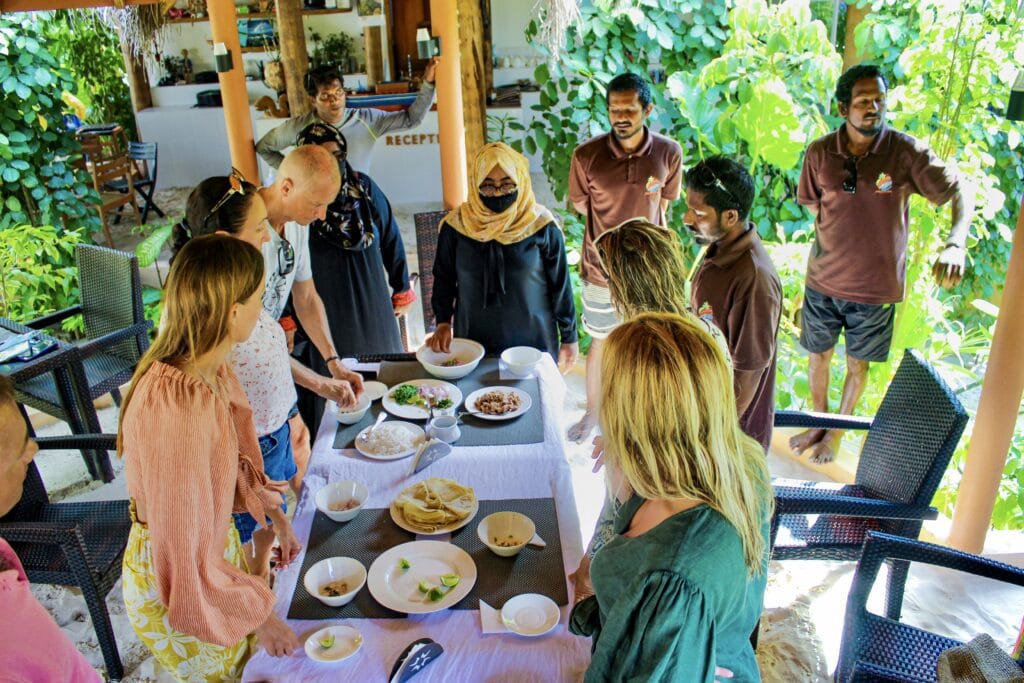 Guests participating in a Maldivian cooking class, learning to make local dishes at Sabba Beach Hotels.