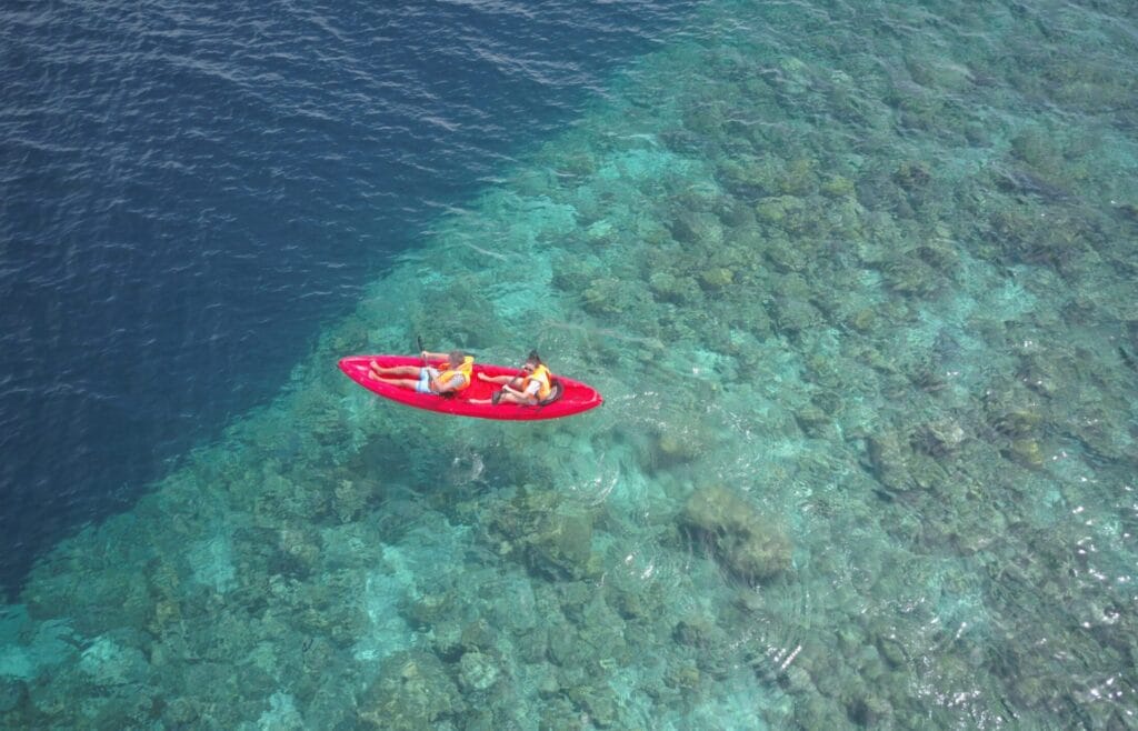 Guests kayaking on the crystal-clear waters of Fodhdhoo Island near Sabba Beach Hotels, Maldives