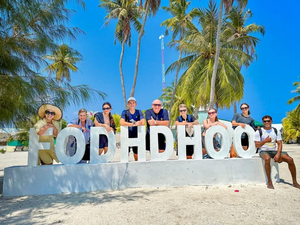 Guest taking a picture near the name of Fodhdhoo Island.