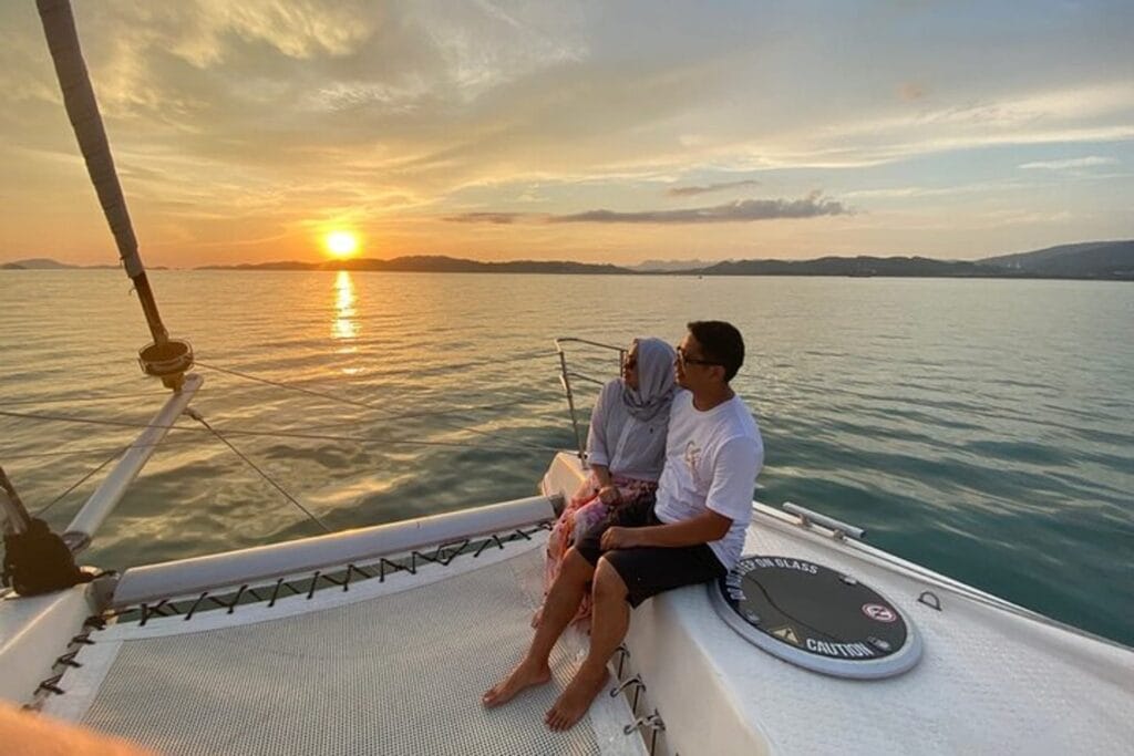 Honeymoon couple on a private sunset cruise in the Maldives near Sabba Beach Hotels.