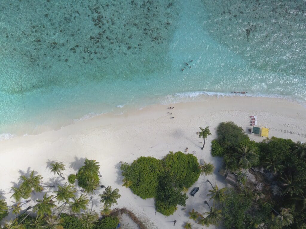 Aerial view of the bikini beach at Sabba Beach Hotels, showcasing a serene vacation at Maldives.