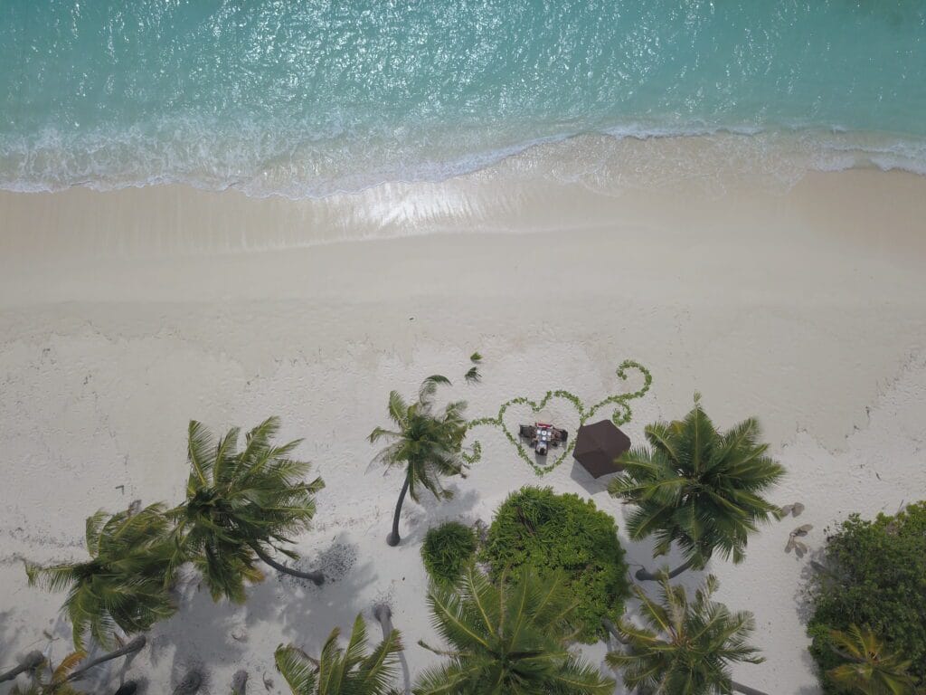 Aerial view of a beachfront dining experience at Sabba Beach Hotels on Fodhdhoo Island."
