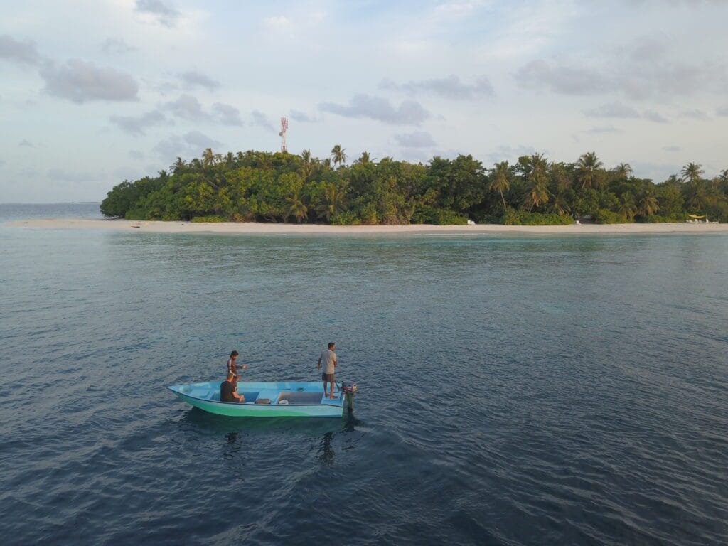 Guest fishing from a small boat near Fodhdhoo Island, enjoying a traditional Maldivian experience.