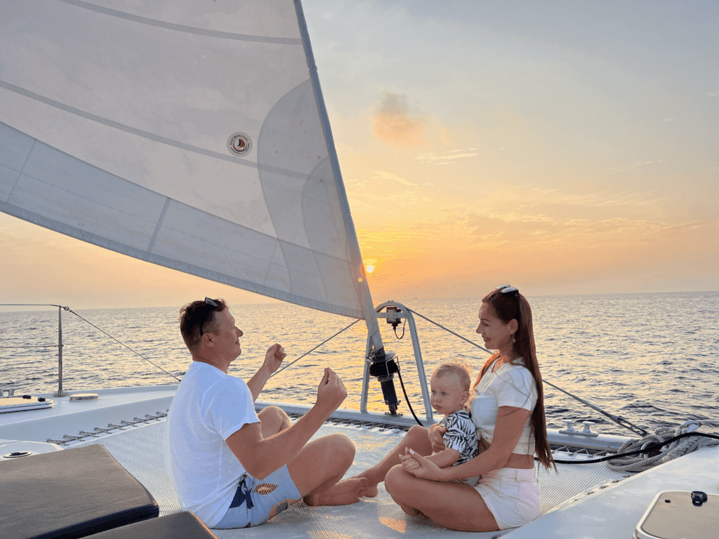 Guests enjoying a serene sunset cruise on the Sabba White Sand Catamaran in the Maldives.