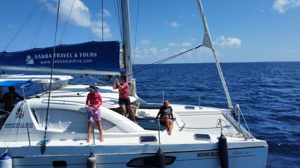 Guests preparing to snorkel from the deck of the Sabba White Sand Catamaran, ready to explore the Maldives' reefs.