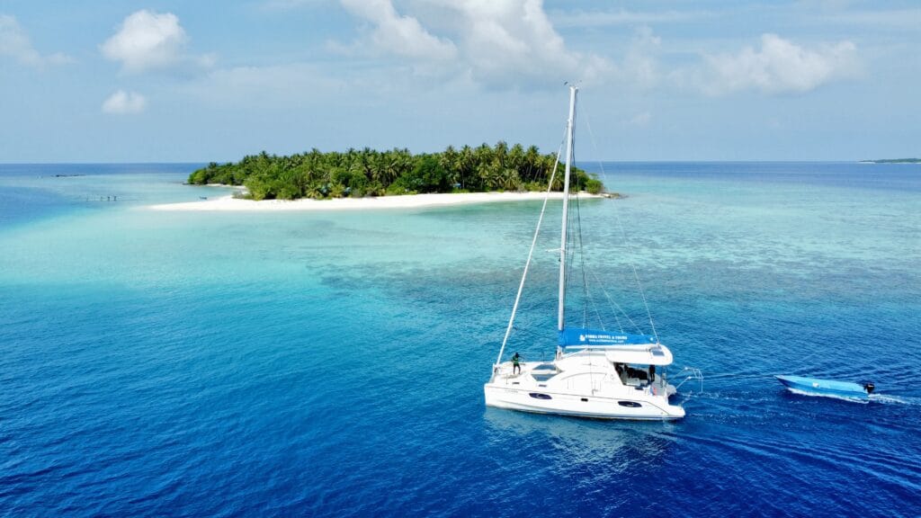 Sabba White Sand Catamaran sailing on clear turquoise waters in the Maldives, ideal for island-hopping adventures