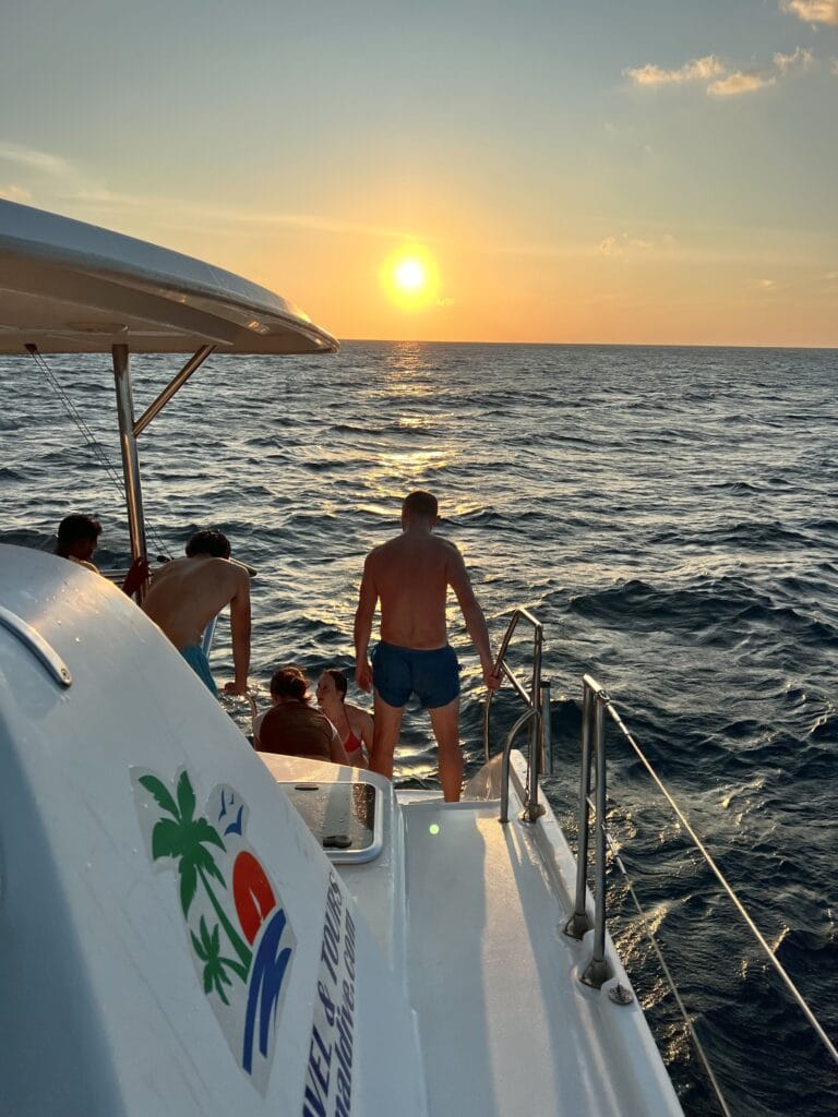 Guests enjoying a serene sunset cruise on the Sabba White Sand Catamaran in the Maldives.