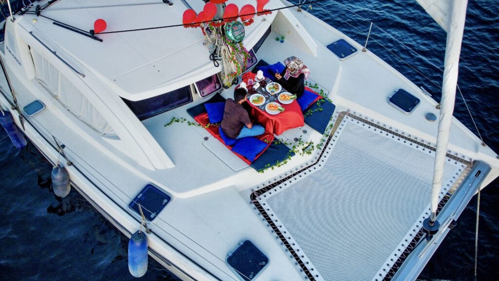 Romantic dinner setup on the Sabba White Sand Catamaran, ideal for couples looking for a unique dining experience in the Maldives.