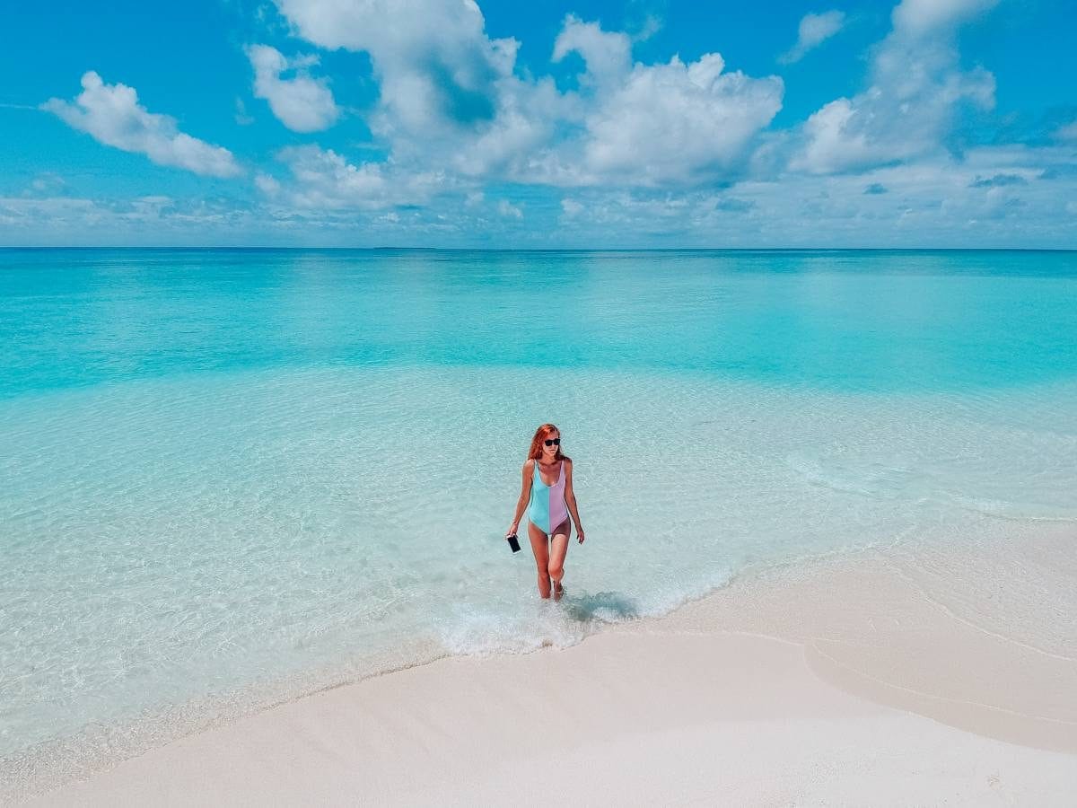 Content traveler gazing at turquoise horizons, celebrating a carefree Holiday at Maldives