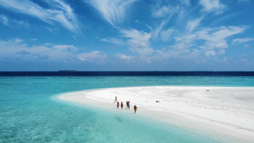 Guests at the sandbank captured from a drone during a Maldives beach vacation on a budget