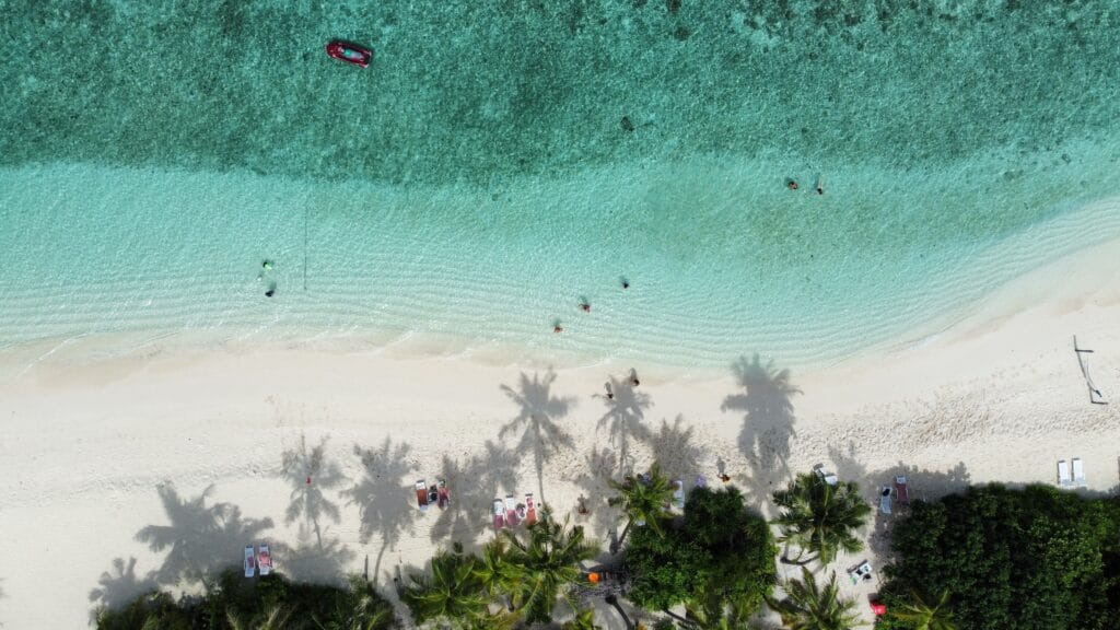 Aerial view of Sabba Bikini Beach area with guests relaxing near the shoreline, experiencing the beauty to Discover Maldives.