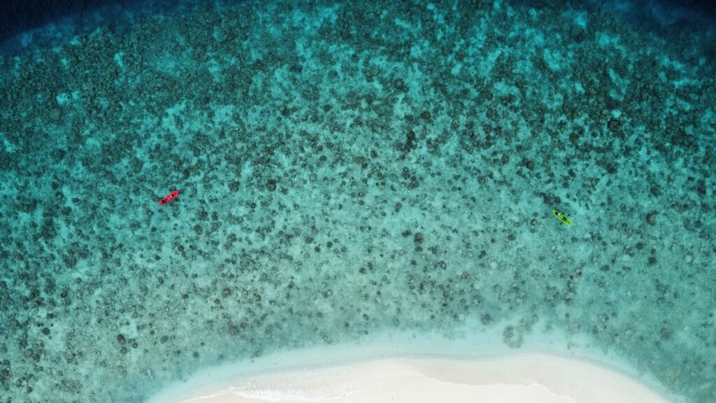 Aerial picture of Fodhdhoo reef, perfect for a Maldives beach vacation on a budget