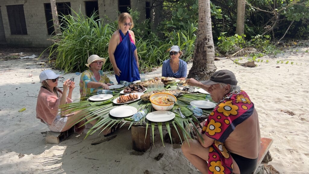 Guests enjoying food the Maldivian way during a budget-friendly beach vacation