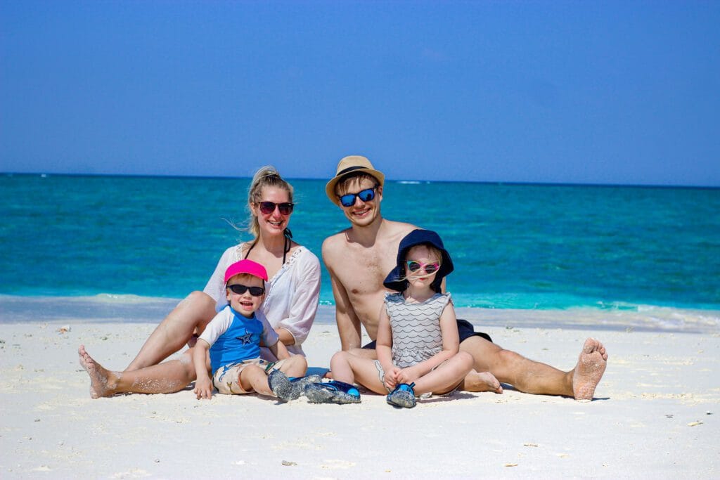 Family enjoying a day at Fodhdhoo Beach during a Maldives beach vacation