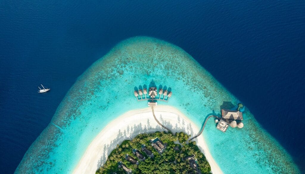 Aerial view of the luxurious Hurawalhi Resort surrounded by turquoise waters.