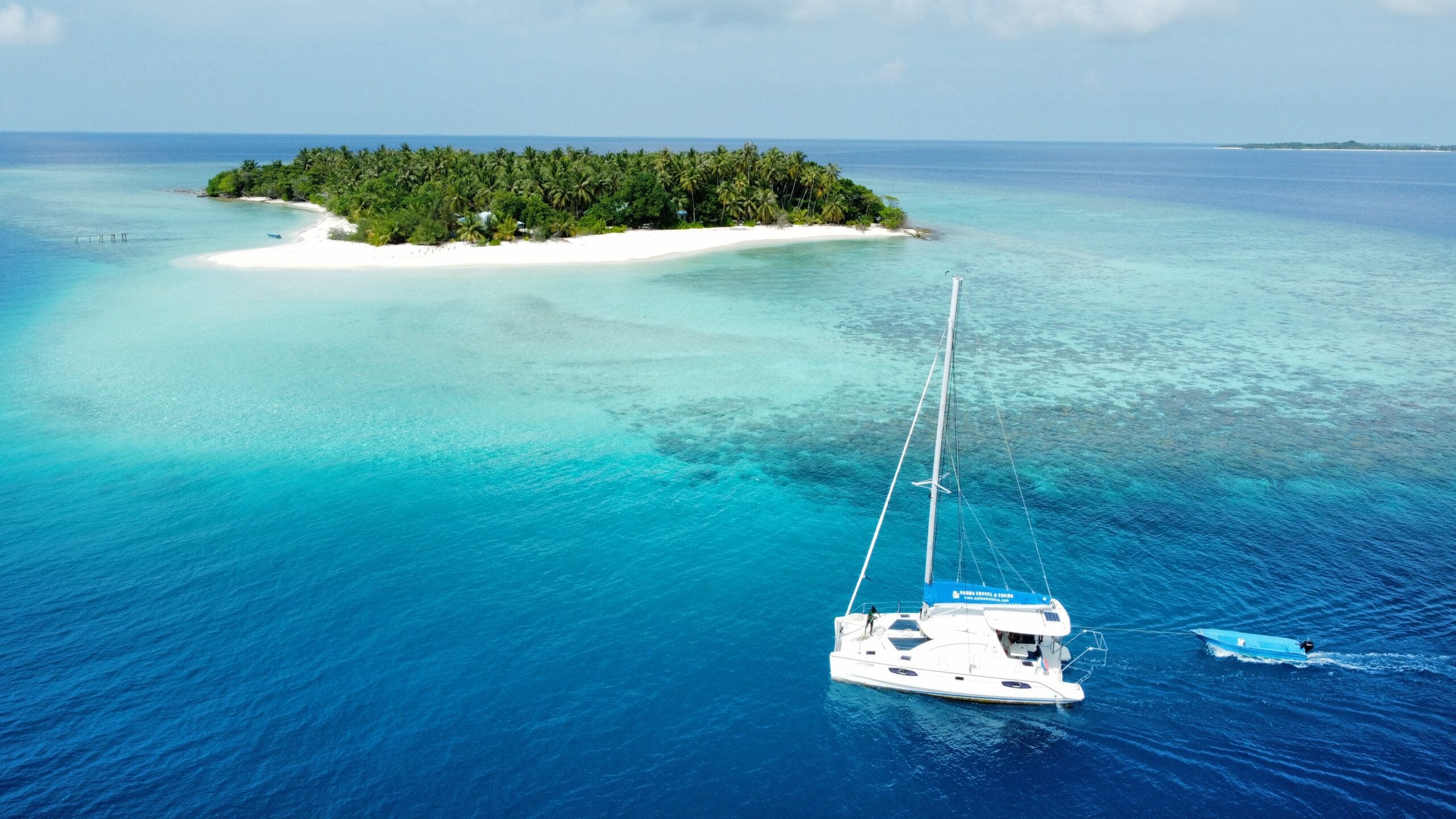 Catamaran gliding across calm seas, exploring hidden corners of the Maldivian atolls