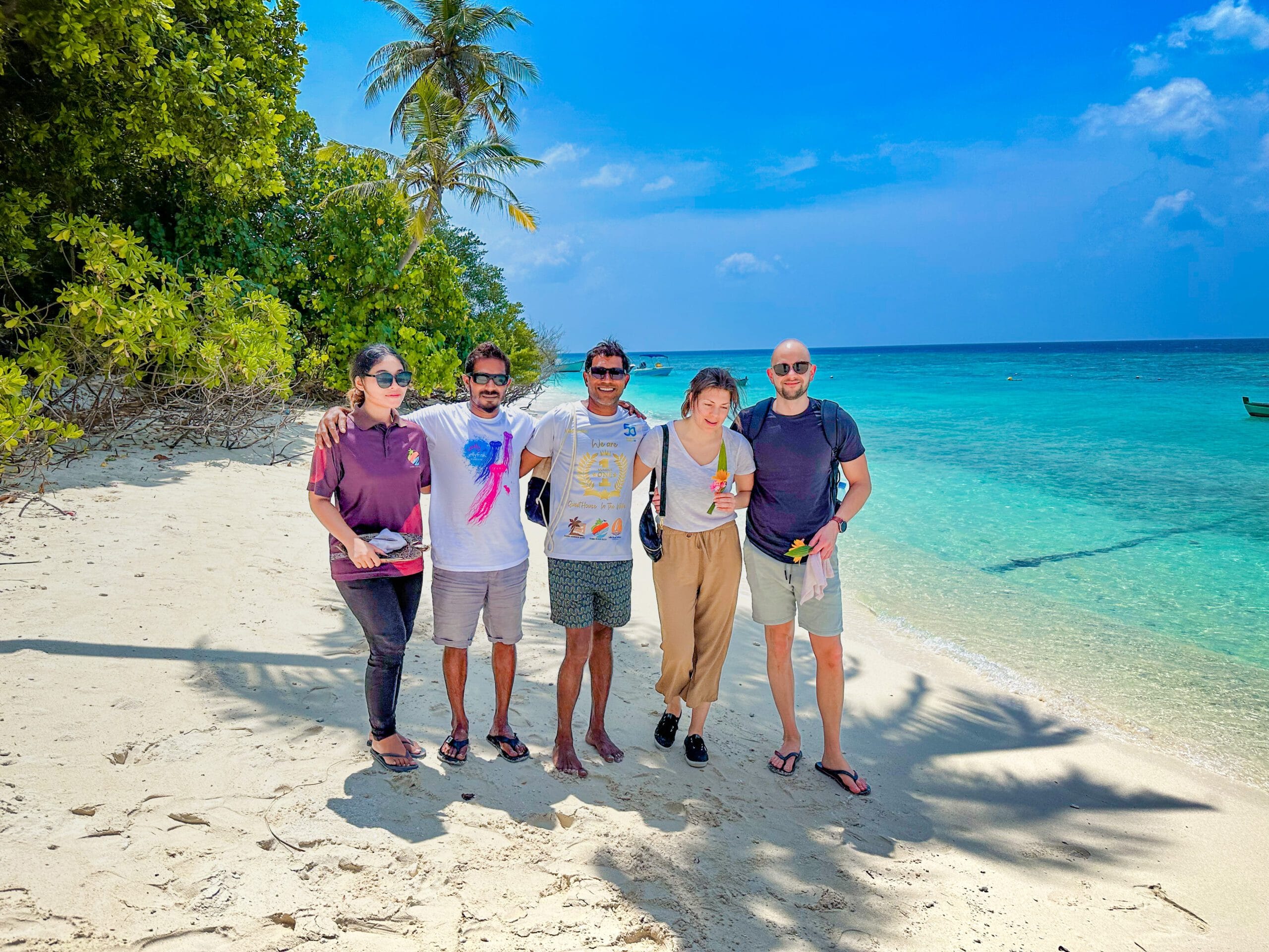 New arrivals commemorating their Holiday at Maldives with a joyful beachside group photo