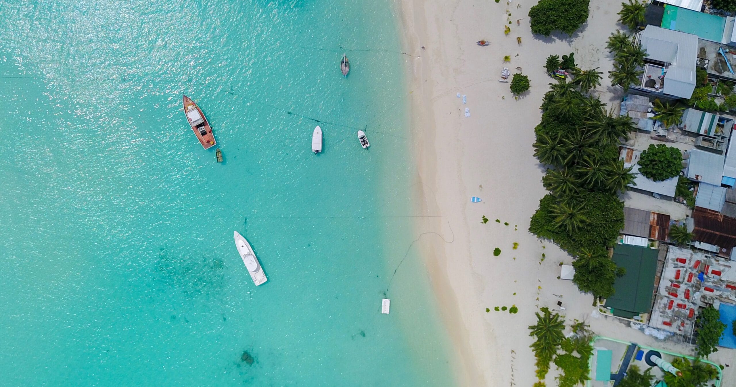 Sweeping aerial glimpse of Sabba Beach Hotels, unveiling pristine shores for an Affordable Guest House Maldives holiday