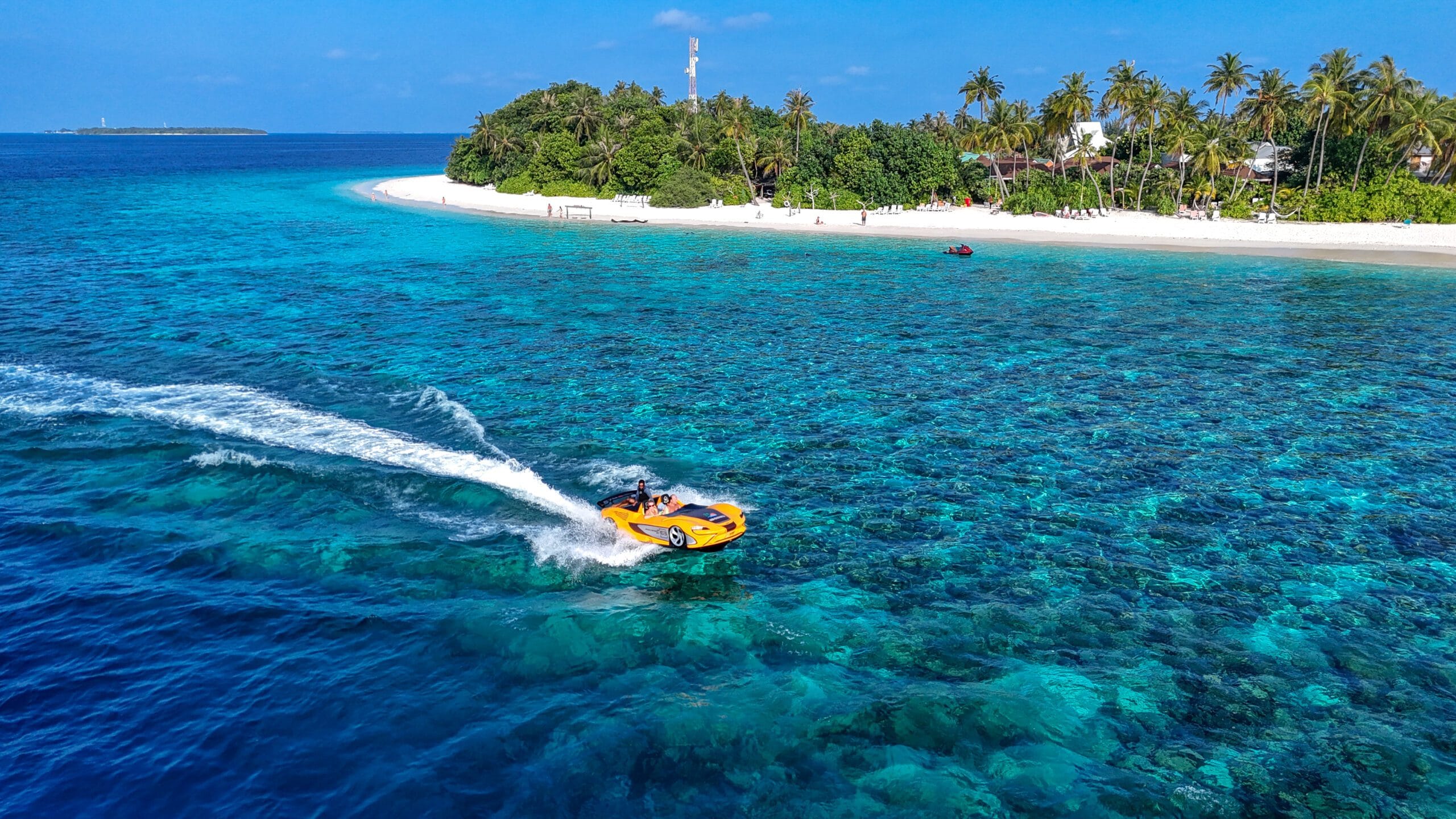 Thrill-seeking guest steering a jet car across clear reef water near Sabba Beach Hotels