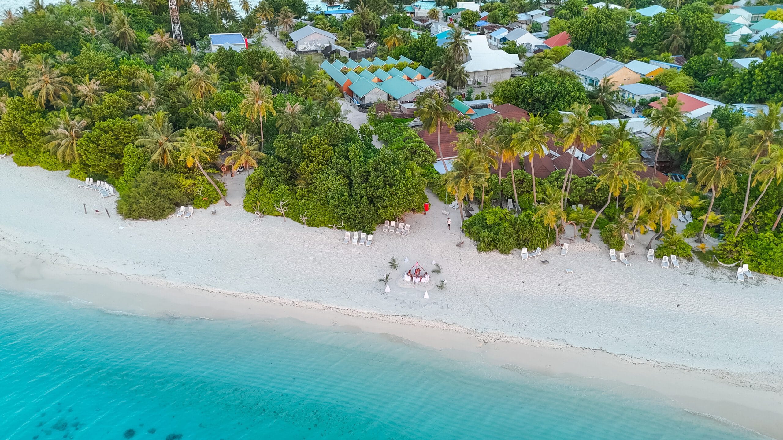 Family sharing a sunset beach dinner on Fodhdhoo—perfect memory from their Maldives For Families stay