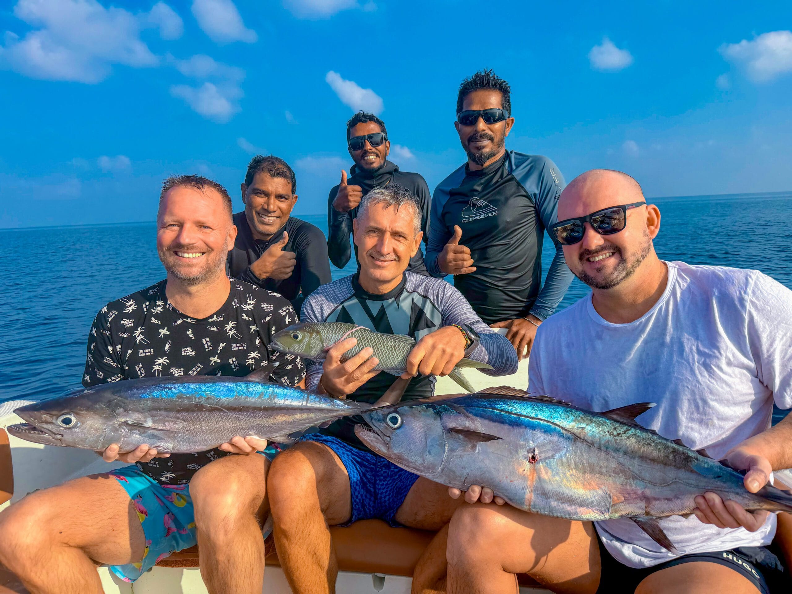 Guest taking a group picture after their fishing trip at Maldives